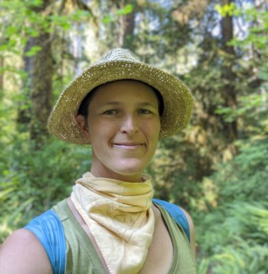 woman in straw hat in forest with yellow neck bandana