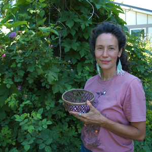 woman in pink tshirt holding basket of rose petals