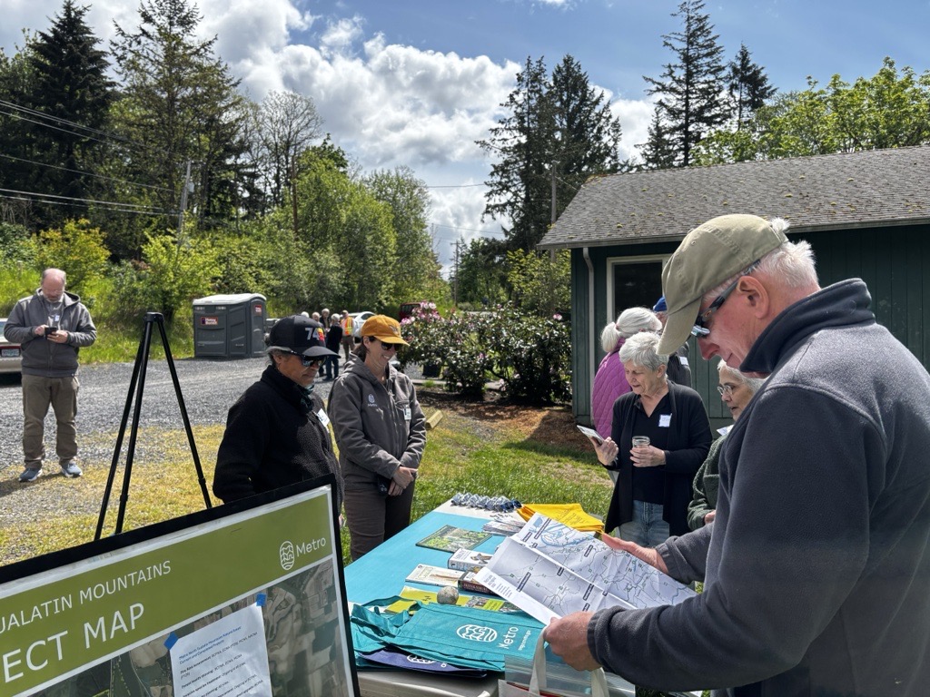 People gather around a table on a sunny day